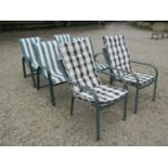 A set of four green painted aluminium stacking garden chairs together with a further similar pair