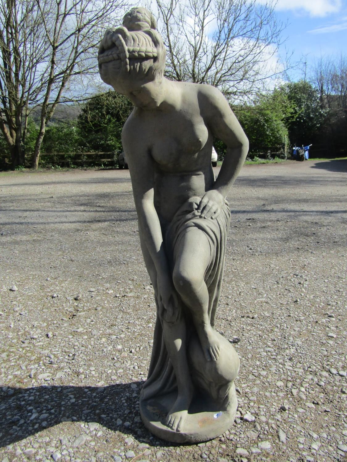 A cast composition stone garden ornament in the form a classical maiden 105 cm high