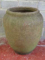 A large weathered terracotta oviform jar/planter with crimp banded neck, 87 cm high x 76 cm diameter