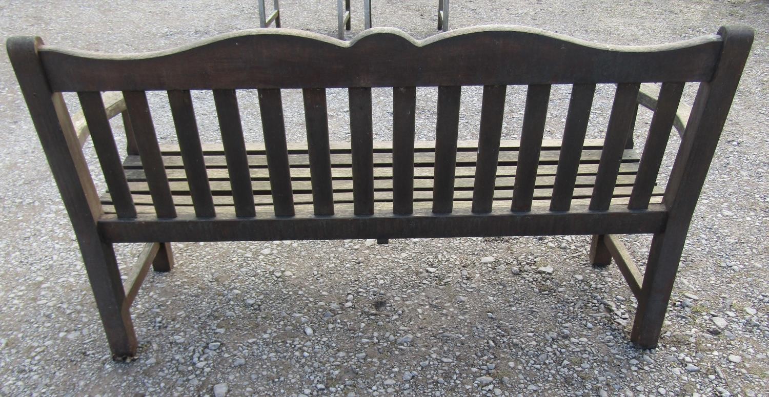 A Bridgman & Co Ltd stained and weathered teak three seat garden bench 161 cm wide and a pair of - Image 8 of 11