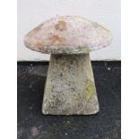 A weathered natural stone staddle stone with domed cap raised on a wide square tapered base approx