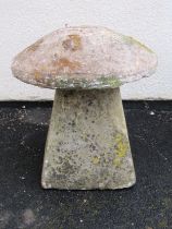 A weathered natural stone staddle stone with domed cap raised on a wide square tapered base approx
