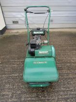 A Qualcast Classic petrol 35S cylinder lawn mower with grass collection box