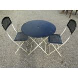 A painted folding steel three piece Bistro set with lattice detail, the table 77cm diameter (af)