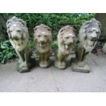 Two pairs of weathered cast composition stone pier ornaments in the form of seated lions, the