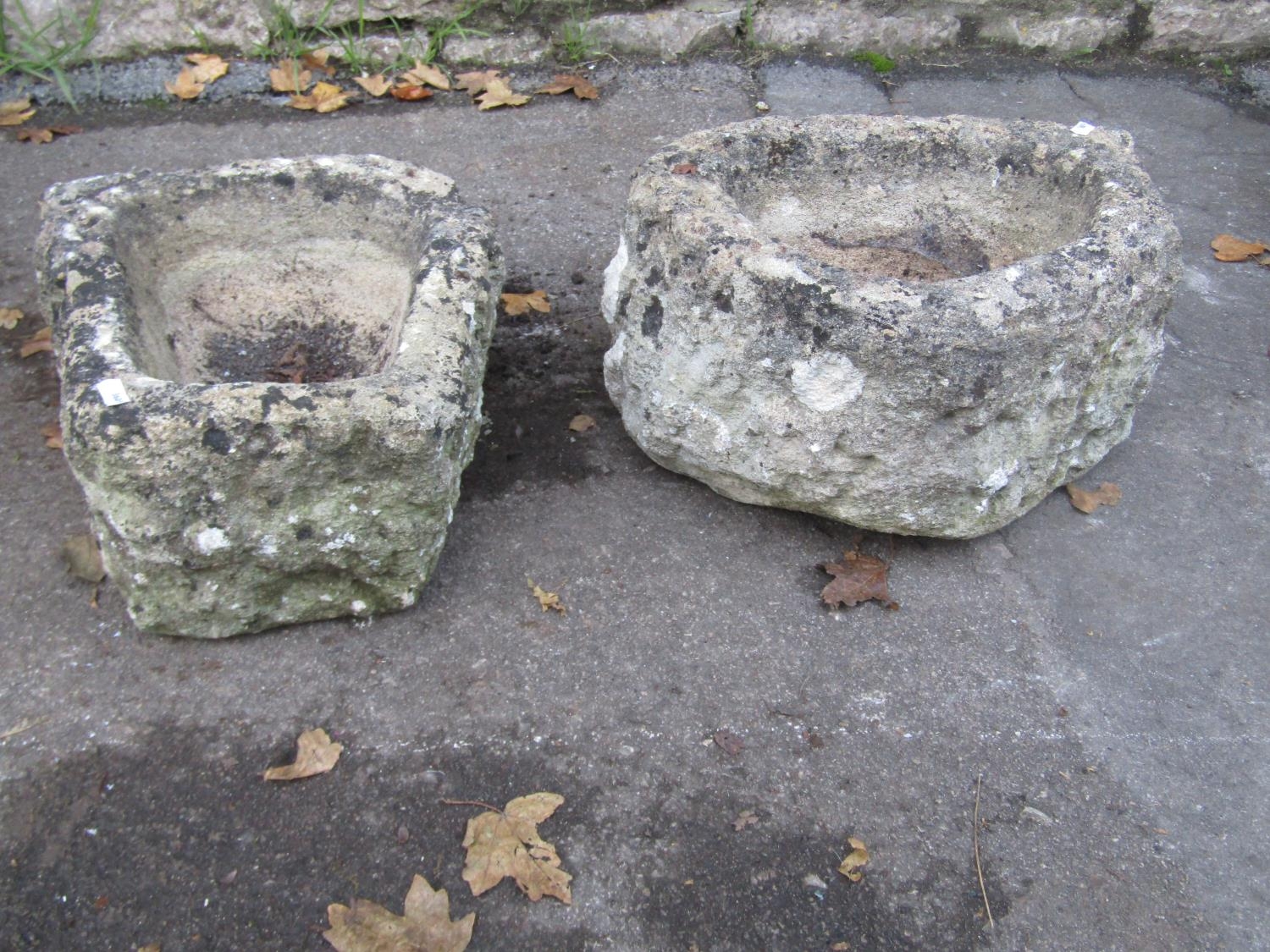 Two small rough hewn natural stone troughs, the largest 40cm wide x 30cm deep x 20cm high, the other