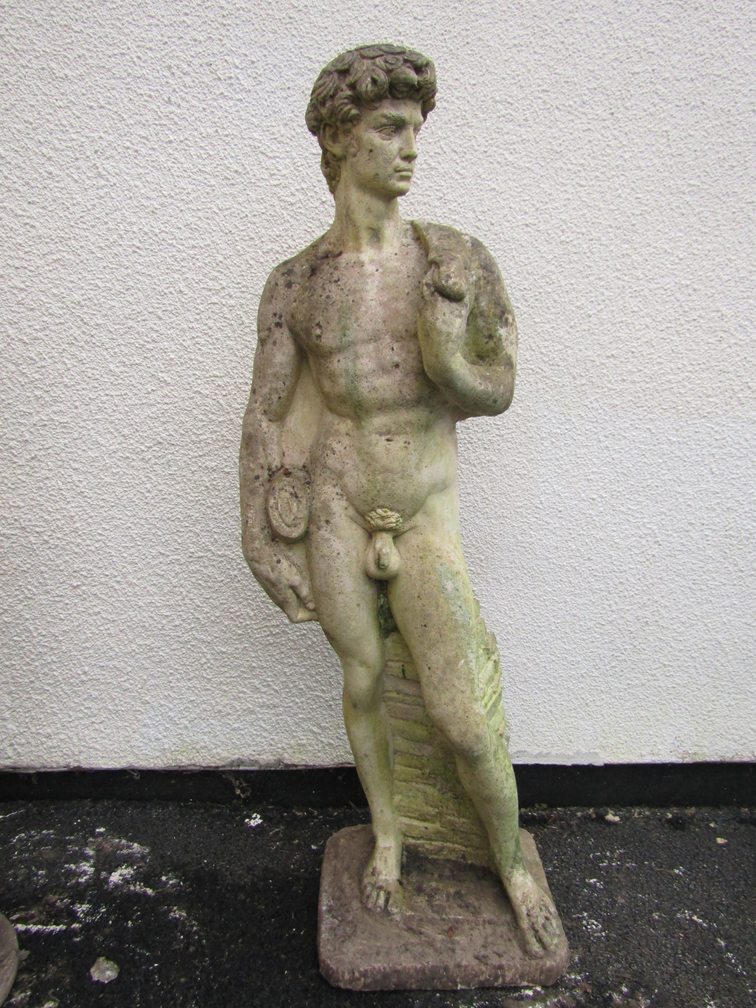 A weathered cast composition stone garden statue of 'David' 117 cm high