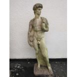 A weathered cast composition stone garden statue of 'David' 117 cm high