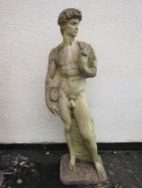 A weathered cast composition stone garden statue of 'David' 117 cm high