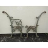 A pair of 19th century cast iron bench ends with dragon and scroll detail 91 cm (full height) (af)