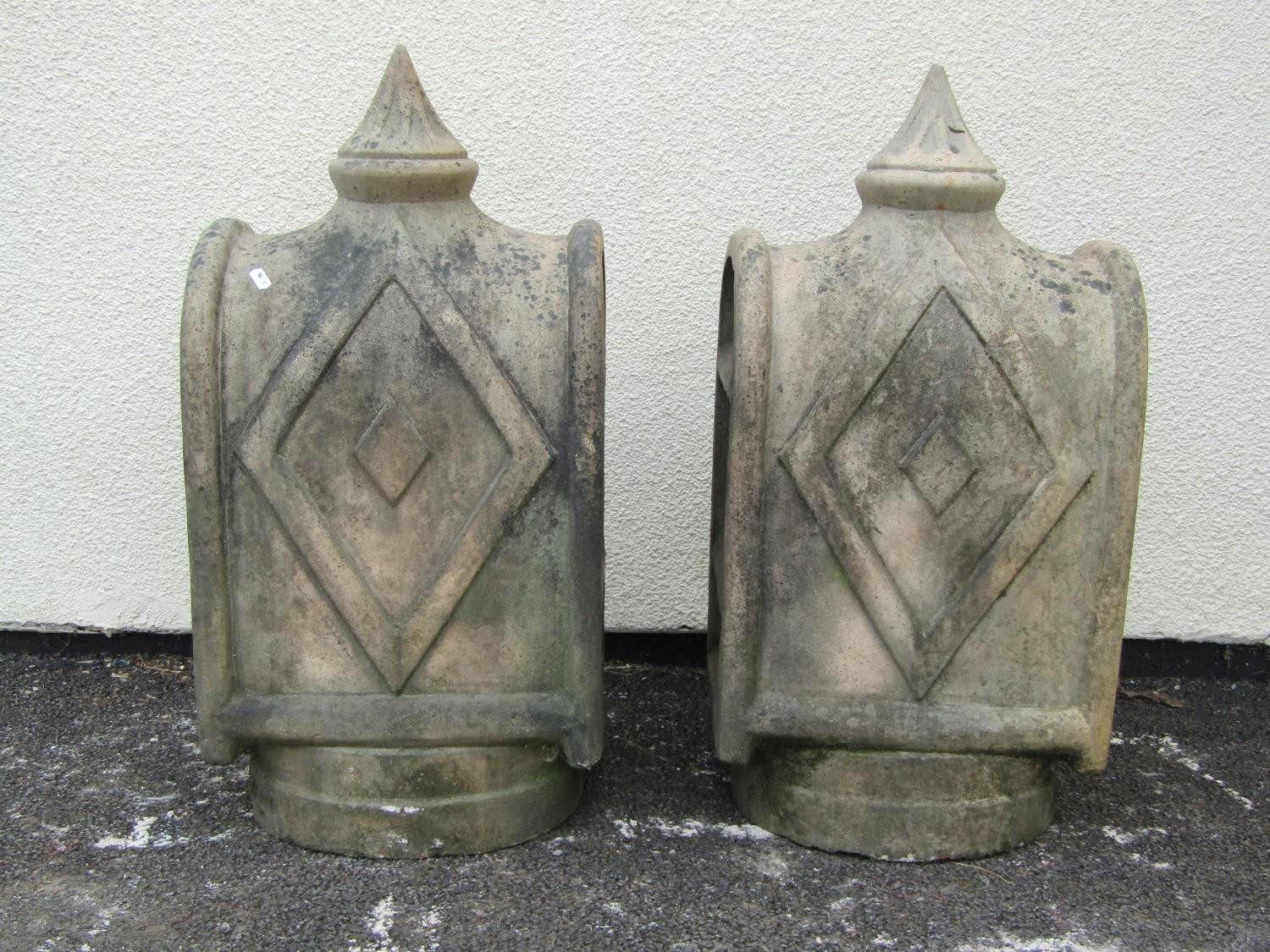 A pair of unusual weathered buff coloured louvre vented chimney pots/cowls of slender arched form