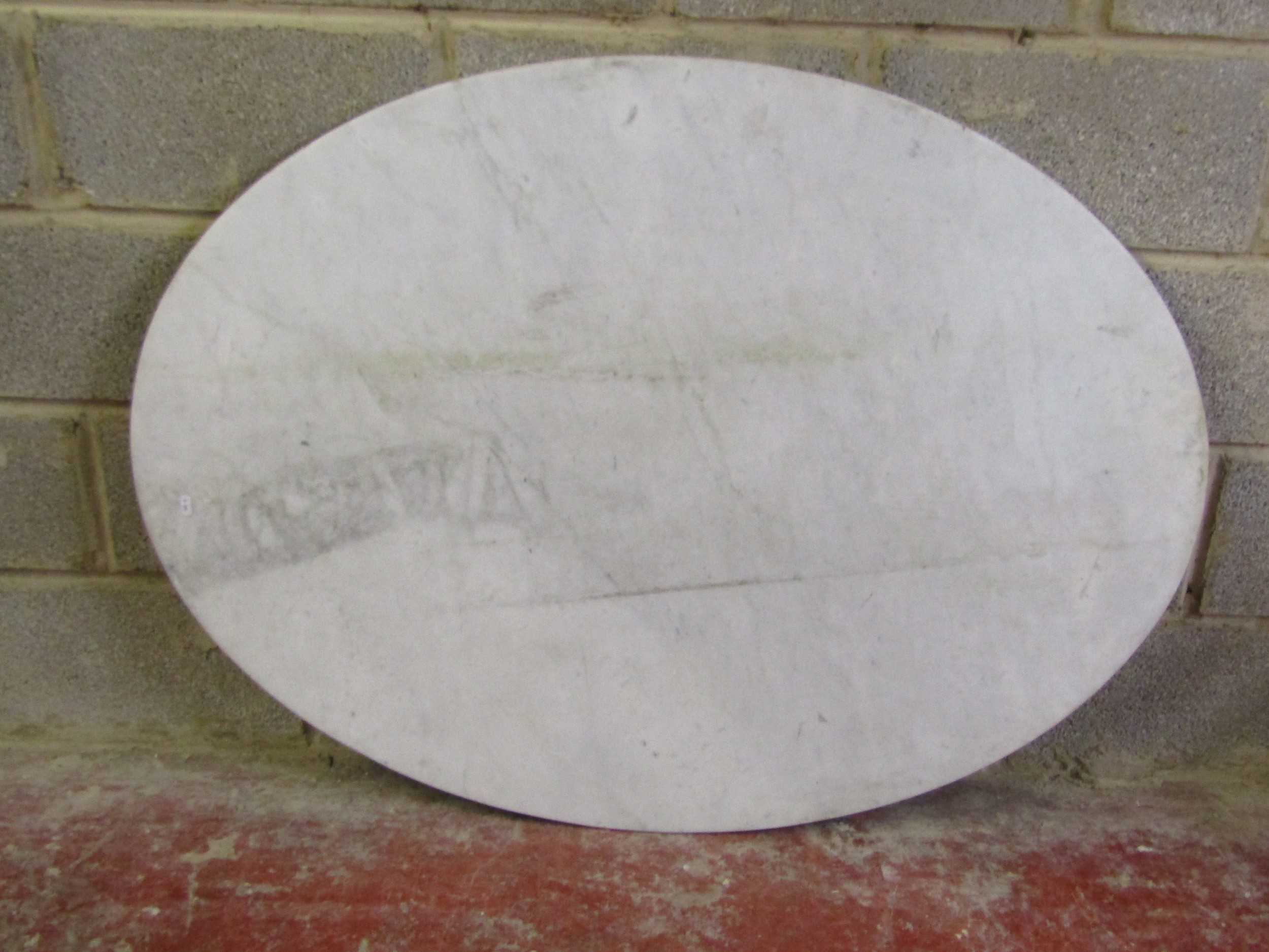 An oval white marble table top with moulded outline, 94 cm x 126 cm