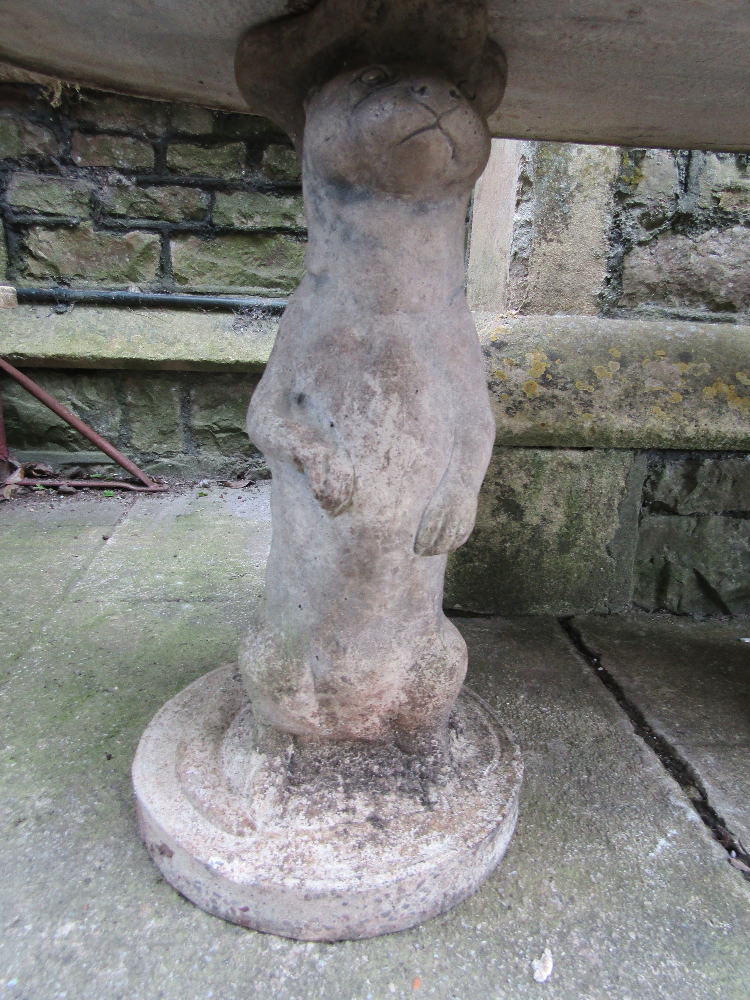 A novelty weathered three sectional composition stone garden table with oval top on standing otter - Image 3 of 4