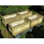 A set of four weathered composition stone garden troughs of rectangular form with repeating owl,
