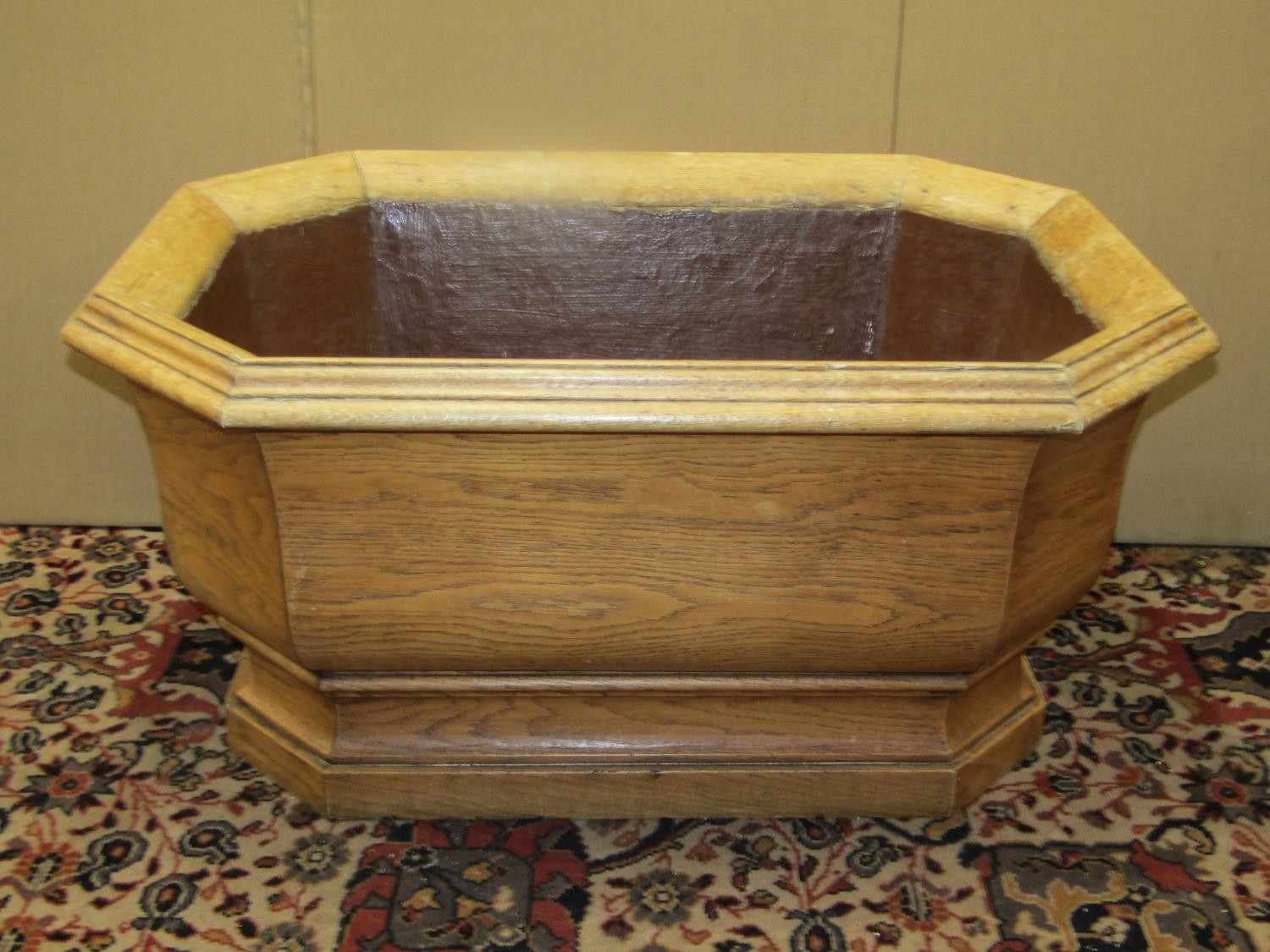 A large 19th oak century pale oak planter to an 18th century design of elongated octagonal form