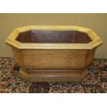 A large 19th oak century pale oak planter to an 18th century design of elongated octagonal form