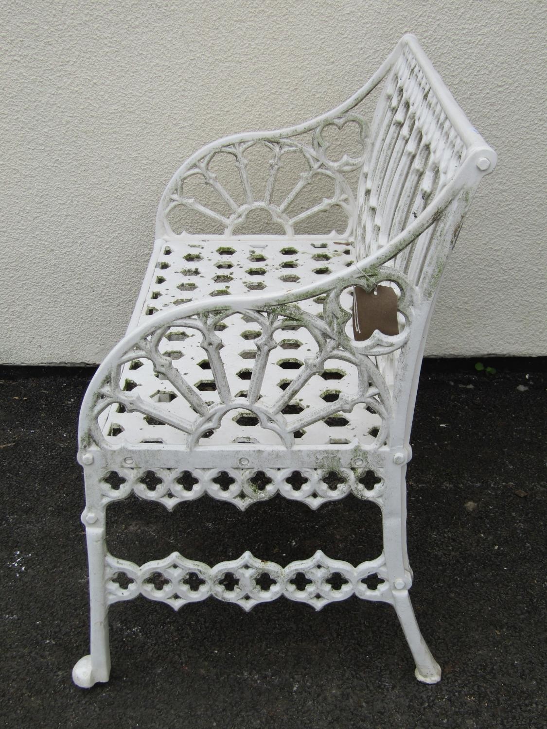 A small cream painted cast alloy two seat garden bench with pierced gothic tracery detail, 87 cm, - Image 4 of 4