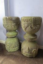 A matched set of four weathered composition stone planters, of pedestal urn form with moulded