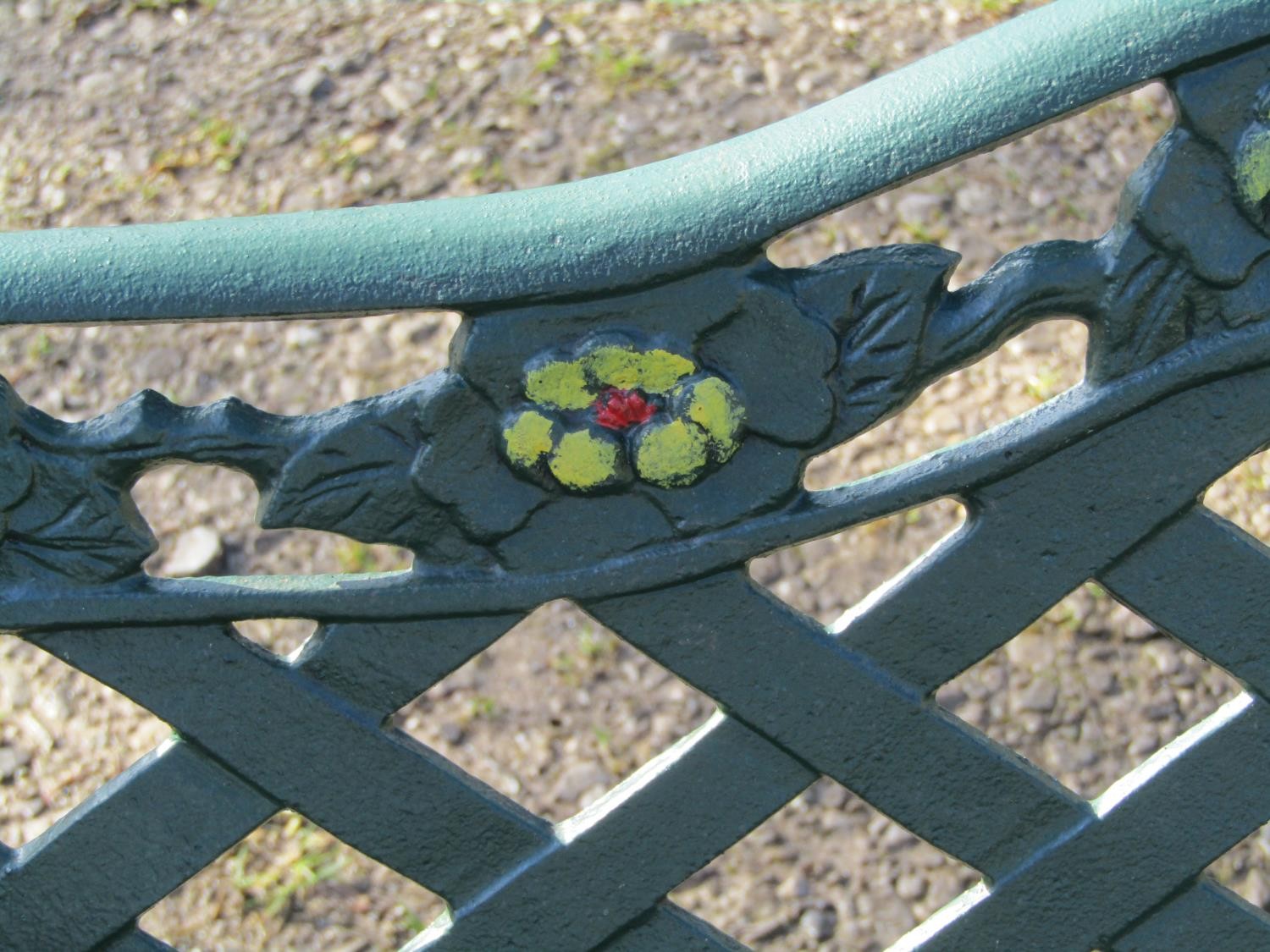 A green painted garden bench with wooden slatted seat beneath a cast iron pierced lattice panelled - Image 6 of 6
