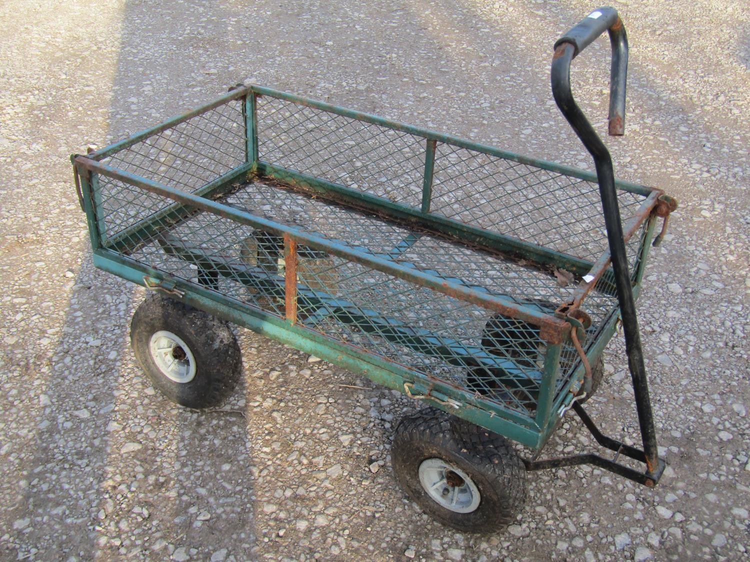 A useful four wheeled hand cart with rectangular green painted steel and lattice panelled body