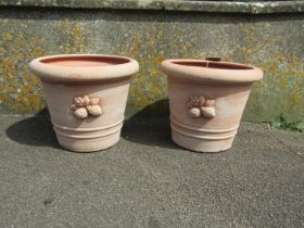 A pair of contemporary terracotta planters with moulded fruit motifs