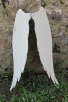A decorative painted and weathered hanging garden ornaments in the form of a pair of angel wings, 64