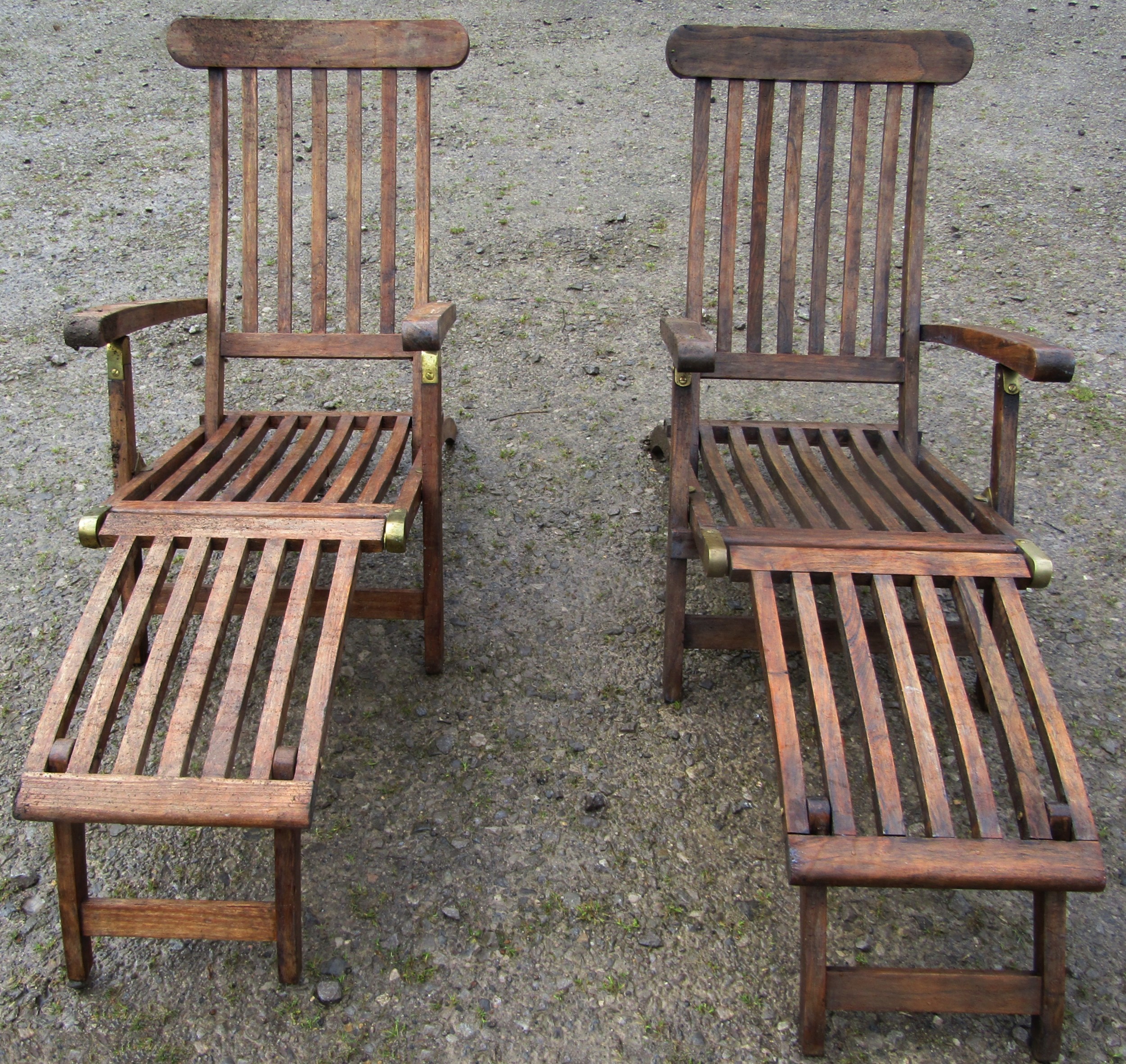 Two similar good quality contemporary hardwood folding steamer type armchairs with slatted seats,