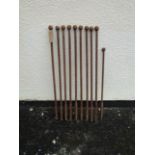 A run of nine antique iron rails/line stakes with ball finials, 77 cm high together with a matching