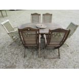 An associated weathered contemporary teak garden suite comprising table with oval slatted panelled