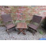 A weathered stained hardwood three piece folding terrace set with slatted detail, the table 50 cm