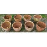 Eight small weathered squat oviform terracotta planters with rope twist collars, 23 cm high x 24
