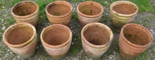 Eight small weathered squat oviform terracotta planters with rope twist collars, 23 cm high x 24