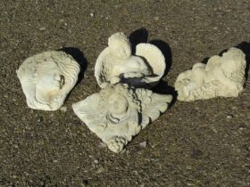 Three small contemporary cast composition stone winged cherub garden ornaments including wall