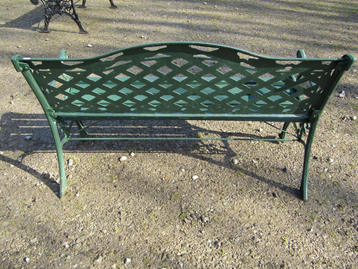 A green painted garden bench with wooden slatted seat beneath a cast iron pierced lattice panelled - Image 4 of 6