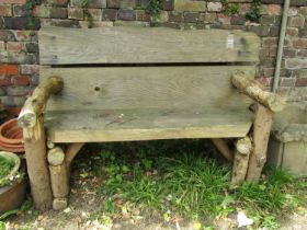 A rustic wooden two seat garden bench 145 cm wide