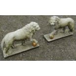 A pair of weathered cast composition stone garden terrace/pier ornaments in the form of standing