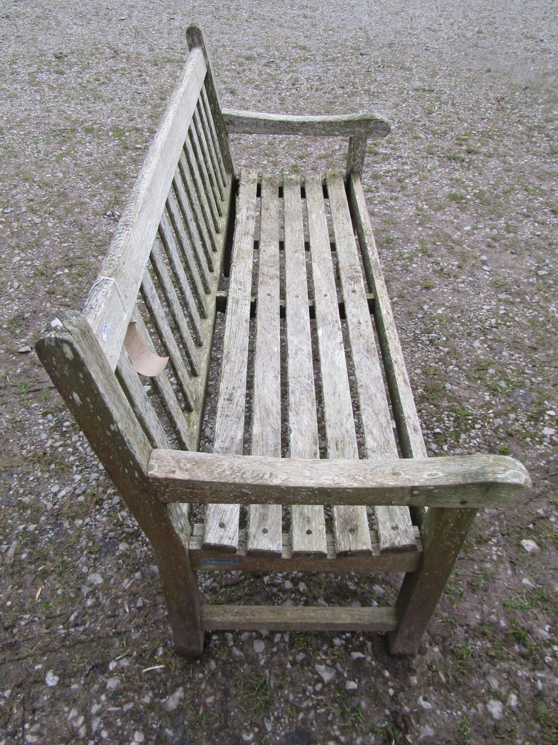 A weathered teak Tiger Trading three seat traditional garden bench with slatted seat and back, 153cm - Image 3 of 5