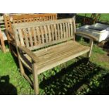 A weathered ‘Canterbury Collection’ teak garden bench with curved slatted seat, back and arms (AF)