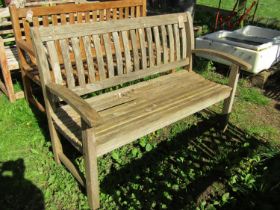 A weathered ‘Canterbury Collection’ teak garden bench with curved slatted seat, back and arms (AF)