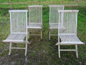 A Bramblecrest weathered teak folding garden table with rectangular slatted panelled top raised on x