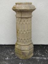A weathered Doulton buff coloured tall gothic design chimney pot of cylindrical form with