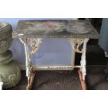 A Victorian cast iron tavern table, the scrolling trestle framework with white painted finish, below