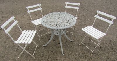 A grey painted cast alloy garden terrace table with decorative circular pierced top raised on