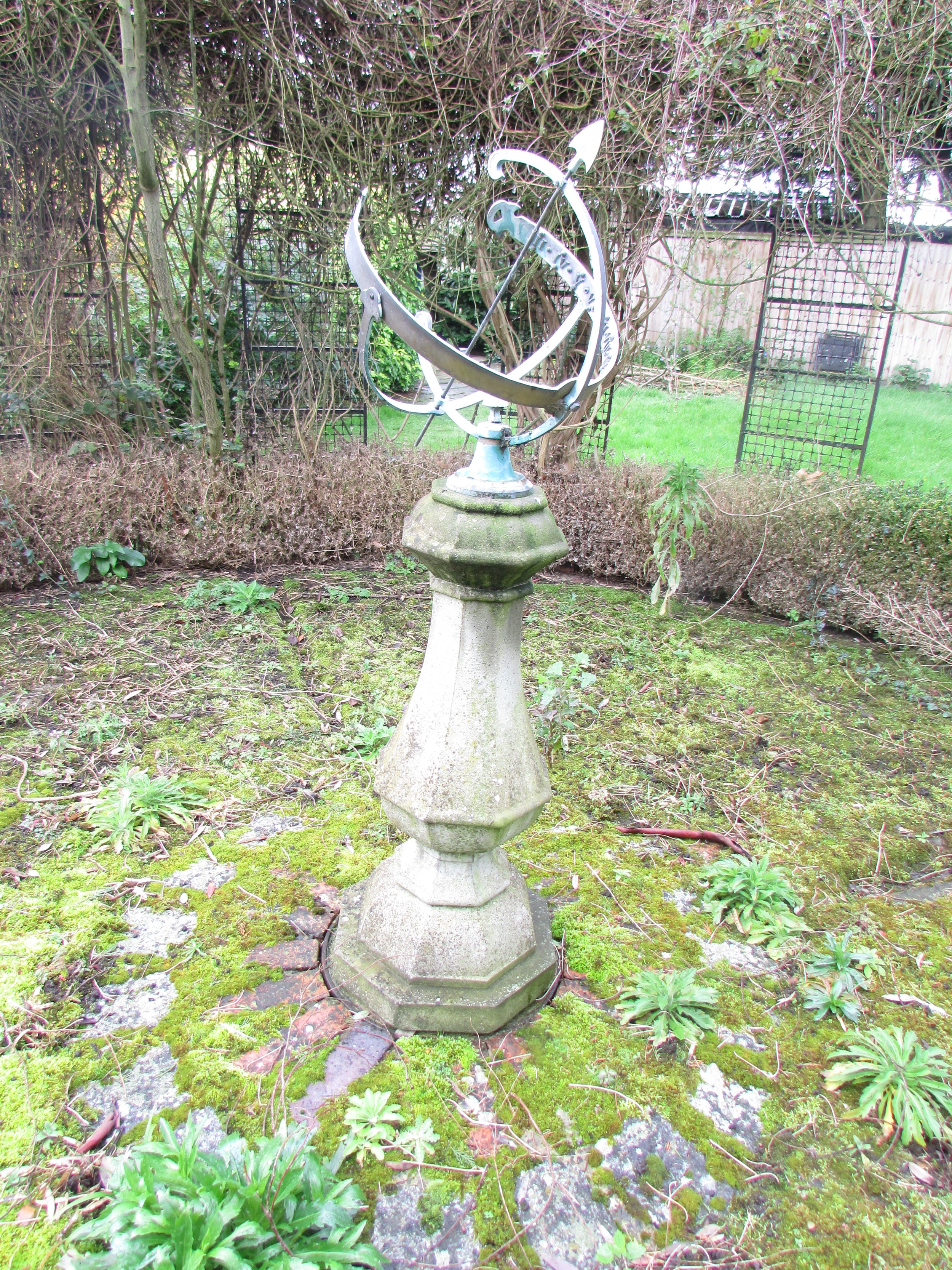 An Armillary sundial raised on an octagonal vase shaped pillar and stepped base, 140 cm (full