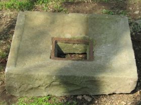 A weathered natural stone square drain cover/surround, 61cm square