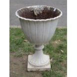 An old painted cast iron garden urn, the circular tapered bowl with crimped edge and fixed socle,