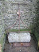 A 19th century (or possibly earlier) large stone garden roller, with wrought iron frame and T shaped