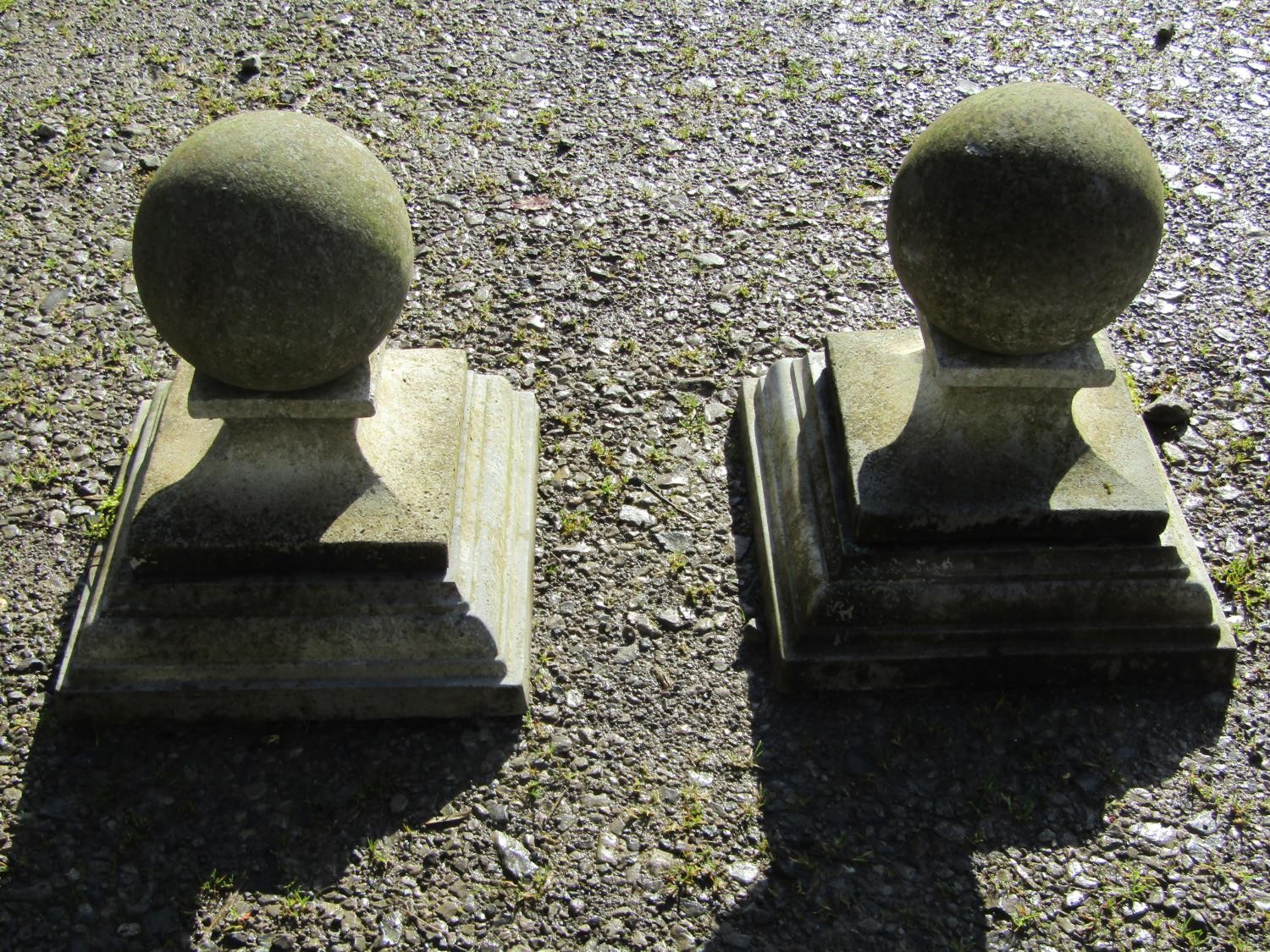 A pair of cast composition stone three sectional pier caps with ball finials, approx 20 cm diameter,