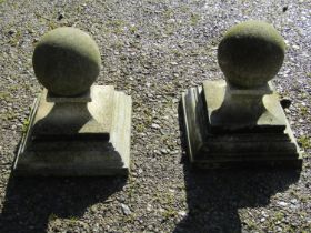 A pair of cast composition stone three sectional pier caps with ball finials, approx 20 cm diameter,