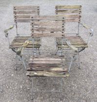 A set of three folding steel framed garden open armchairs with weathered timbered slats, 63 cm